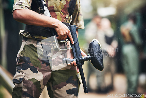 Image of Soldier, paintball gun and ready for war, game or military fight in extreme sports in the outdoor arena. Sporty army player in holding fire in preparation for match start, begin or commence at field