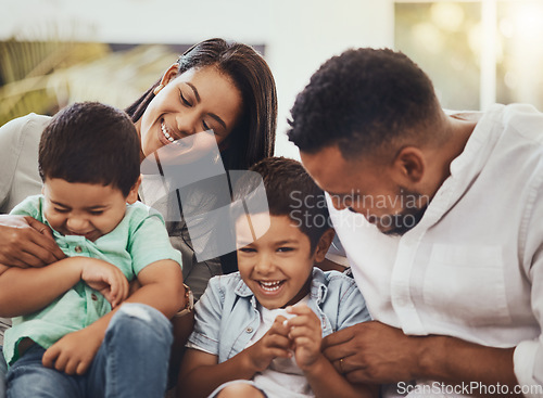 Image of Love, happy and parents tickling their children in the outdoor backyard of their family home. Happiness, smile and young couple spending quality time, bonding and fun with their kids in house garden.