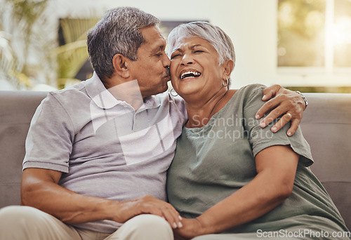 Image of Happy, senior couple and kiss of elderly woman and man laughing with happiness on a sofa. Living room, couch and marriage support of people in retirement with love and joy together in a house lounge