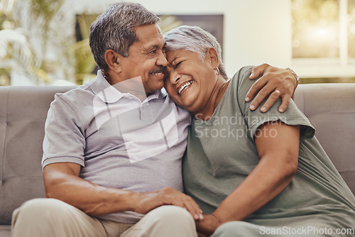 Image of Happy, love and senior couple on a sofa hugging, bonding and relaxing together in their living room. Happiness, laugh and elderly man and woman pensioners in retirement embracing on a couch at home.