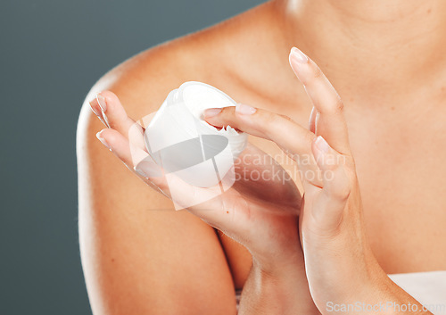 Image of Hand, cream and skincare beauty of a woman with moisturizer product in hands in studio. Isolated, gray background and person with cosmetic, dermatology and spa lotion for skin and female body glow