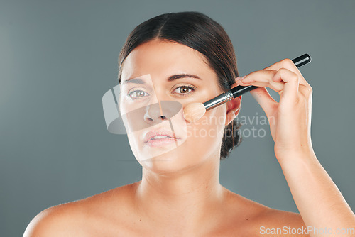 Image of Woman, beauty brush and makeup portrait for wellness, cosmetics dermatology and skincare in studio. Model, facial application and cosmetology lifestyle or luxury product tools for self care glow