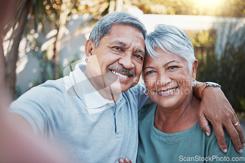 Image of Love, selfie and portrait of a senior couple sitting outdoor in the backyard of a house. Happy, smile and elderly man and woman pensioners in retirement taking picture while relaxing in a home garden