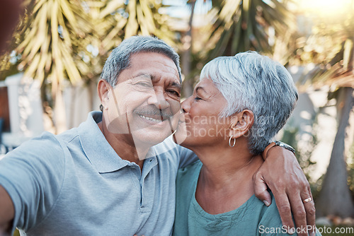 Image of Senior couple, selfie and kiss outdoor portrait with love, happiness and care with a smile in garden. Happy retirement, profile picture and hug of elderly people enjoying life and marriage