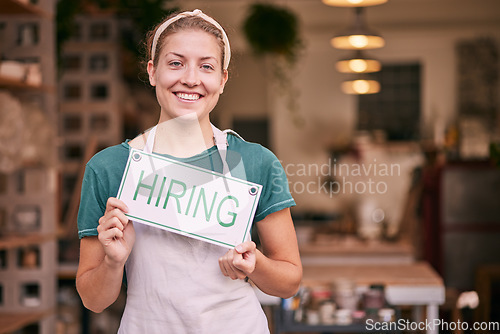 Image of Woman, small business owner and hiring sign with smile for recruitment, job or startup at pottery store. Portrait of happy CEO manager holding board for hire, opportunity or recruiting at retail shop