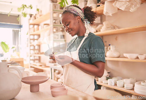 Image of Pottery, craft and black woman creating with clay for her small business in creative workshop. Creativity, handicraft and African female potter entrepreneur manufacturing product with mud for a store