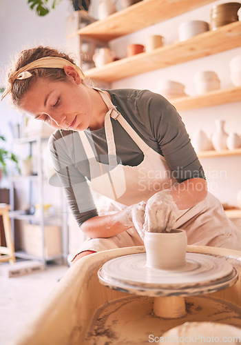 Image of Woman, clay artist and pottery wheel for sculpture design, creative manufacturing and expert focus in studio workshop. Female, mud process and small business designer working with ceramic craft