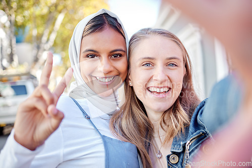 Image of Selfie, peace sign and couple of friends with social media post, profile picture and gen z portrait in city park. Photography, smile and happy diversity or muslim teenager with hand sign on internet