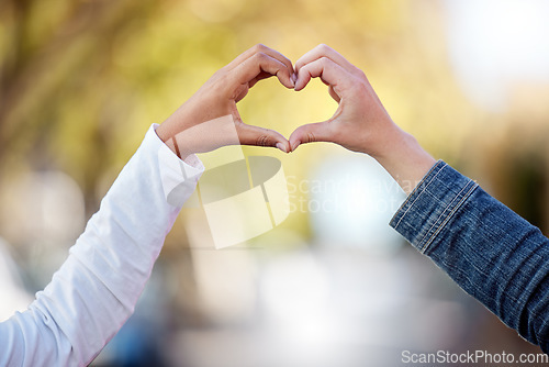 Image of Heart sign with hands, love and couple outdoor, commitment and care in relationship, trust and support. People with connection, wellness and team together in nature, emoji or icon with partnership
