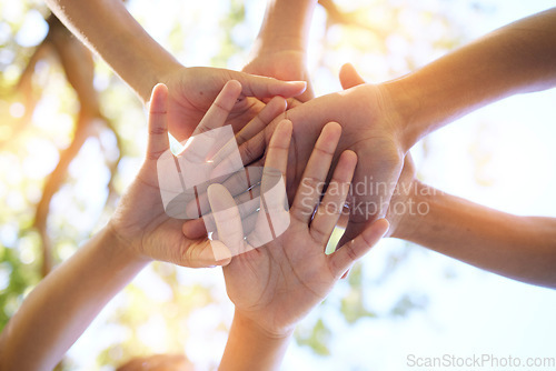 Image of Hands, community and group in unity for trust, support or teamwork goals piling together below for collaboration in nature. Hand of people in solidarity, union or coordination for united team effort