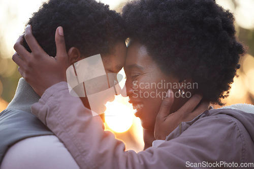 Image of Couple, love and hiking in sunset kissing and faces touching outdoors after workout, fitness and exercise. Romantic African American healthy people affectionate after training together in nature