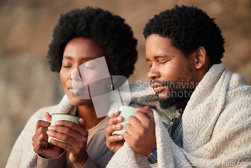 Image of Relax, peace and camping with black couple and coffee for wake up, hiking and sunrise. Nature, calm and adventure with man and woman and blanket in nature for trekking, mountaineering and discovery