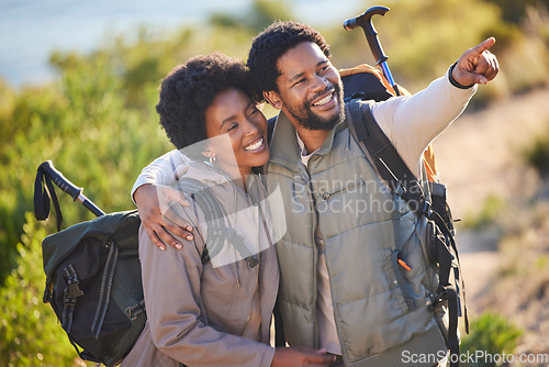 Image of Black couple, happy and pointing on hike adventure for outdoor exploration, sightseeing and journey. Happiness, love and care of people trekking with backpack together with excited smile for travel.