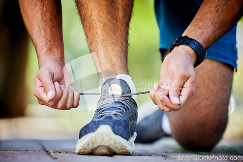 Image of Fitness, running and man tie shoes for exercise, marathon training and cardio workout in outdoor park. Sports, performance and zoom of runner with sneakers lace for wellness, healthy body and jog