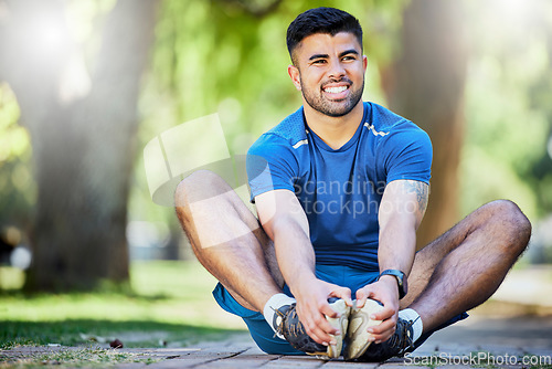 Image of Fitness, exercise and a man stretching outdoor at park for cardio workout, training and muscle warm up. Happy sports person or athlete in nature for a run and energy for health and wellness goals