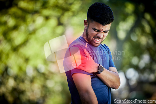 Image of Man, exercise and outdoor with sports injury, joint pain or health problem in nature park during run. Fitness person with hand on arm or muscle after accident during workout or training fail