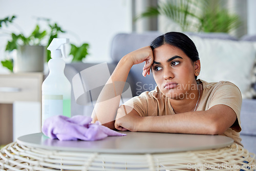 Image of Cleaning, tired and bored with a woman in the living room of her home for hygiene or housework.Depression, burnout and housekeeping with a frustrated female cleaner in an apartment domestic work