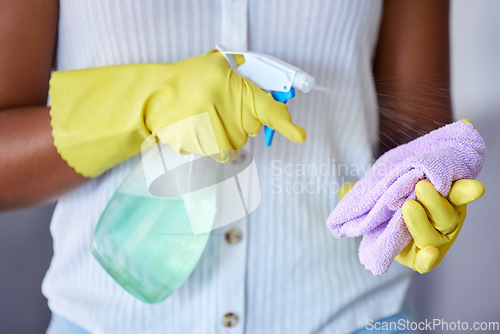 Image of Woman cleaner, spray bottle and cloth for hygiene, health or safety to stop bacteria in home for wellness. Spring cleaning expert, chemical liquid and fabric material in hands with service