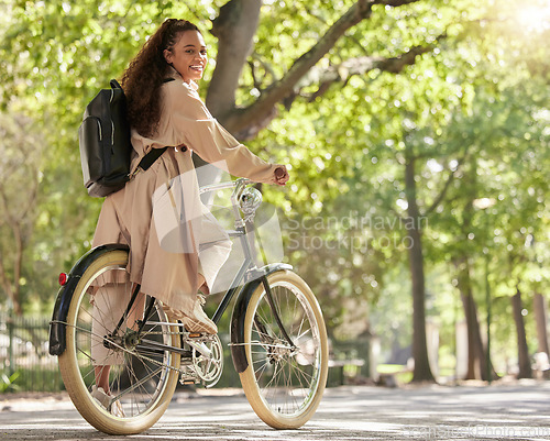 Image of Bicycle, bike and woman travel in a park outdoors in nature happy and excited on fun ride or commuting. Exercise, wellness and lifestyle female student cycling and relaxing on eco friendly traveling