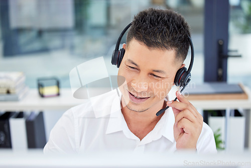 Image of Call center, contact us and customer service worker consulting or working telemarketing in the office. CRM, help and happy male agent, consultant or employee smiling on a call using a headset