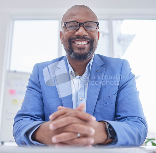 Image of Businessman, CEO and portrait smile for management, leadership or corporate executive sitting by office desk. Happy African American male manager smiling for entrepreneurship, sales or investment