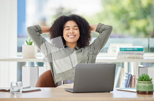 Image of Black woman, laptop and smile in relax by office desk for job done, tasks or work break at a workplace. African American female employee designer smiling and relaxing or stretching by computer table