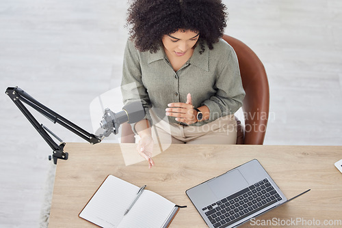 Image of Microphone communication, laptop and black woman streaming podcast, radio talk show or speaker giving trading advice. Online broadcast, live streaming video call and top view of business influencer