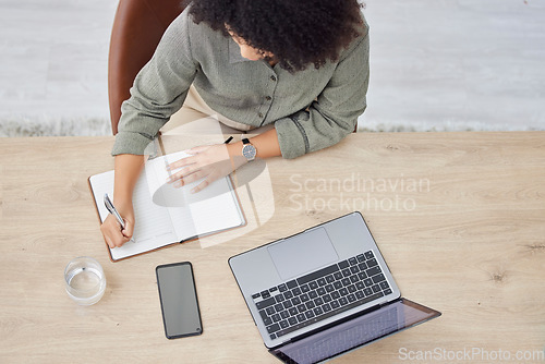 Image of Laptop, writing and notebook with a business black woman at work on a schedule in her office from above. Computer, research and overhead with a female employee planning while working at a desk