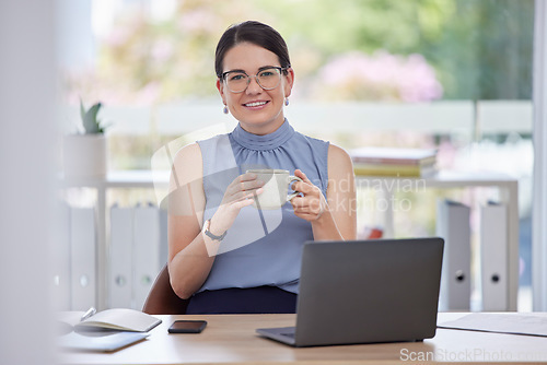 Image of Portrait, coffee and laptop with a business woman taking a break while working on a report in her office. Computer, tea and relax with a female employee drinking a beverage while sitting at work