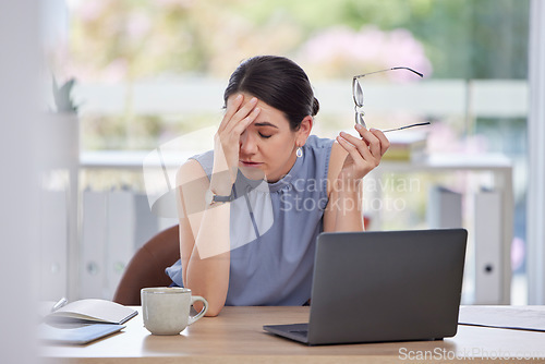 Image of Stress, headache and business woman in the office doing research or planning a corporate strategy. Migraine, exhausted and tired professional female working on a project with a deadline on a laptop.