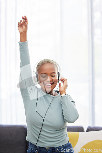 Image of Music, dance and happy black woman listening to African radio, audio podcast or digital playlist song. Wellness girl, dancing energy and excited dancer hearing, enjoy and streaming sound at home