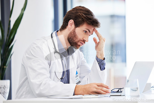 Image of Headache, stress and anxiety of doctor on laptop reading hospital data, results and news fail, mistake or error. Tired, burnout or depression of medical professional with mental health research on pc
