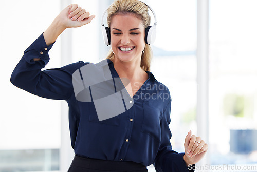 Image of Dancing woman listening to music in office for energy, fun and happy celebration with mental health wellness. Excited, smile and success or dance worker or person in headphones and audio technology