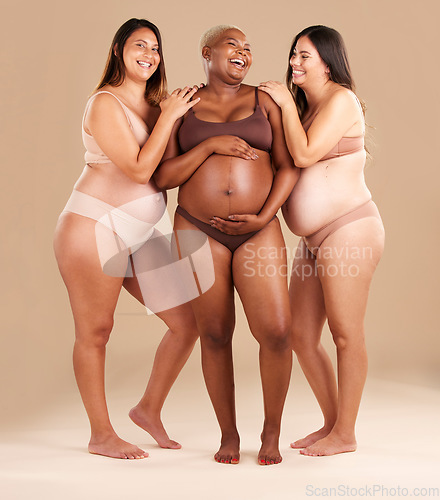 Image of Pregnant body, laughing and women diversity on studio background in empowerment, baby support and community. Smile, happy and pregnancy friends in underwear with funny family planning joke