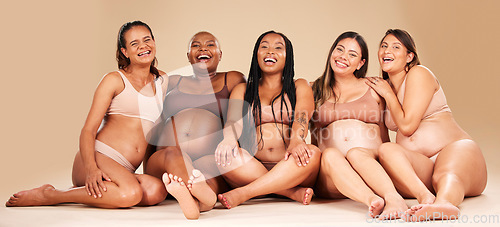 Image of Women group, studio portrait and pregnancy happiness with diversity, smile and solidarity by background. Support, pregnant friends and happy with excited face, future and sitting for hug by backdrop