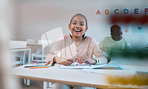 Image of Education, learning and portrait of child with smile in classroom for reading, writing and math in Montessori school. Books, students and happy girl at desk with fun notebook studying for future exam