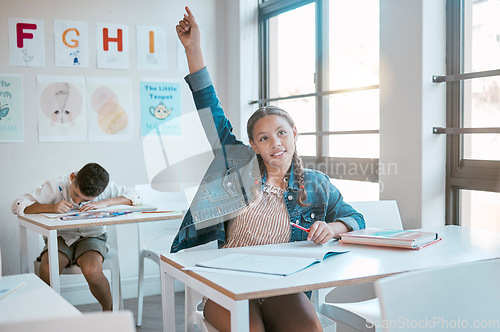 Image of Education, black girl in class and question with hand in air, studying and learning for knowledge, answer or excited. African American female, young kid or child with arm raised for asking and growth