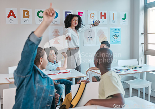 Image of Teacher, classroom and education at school with children learning the alphabet and answer a question. Raised hands, learners and tutor teaching for child development in a class with smart kids
