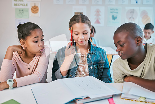 Image of Education, thinking and group of children in classroom working together on project in Montessori school. Books, help and diversity, students writing math test, brainstorming and helping with answers.