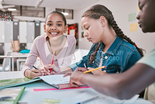 Image of Education, students and portrait of girl in classroom with friends working together on project in Montessori school. Books, help and diversity, children writing or drawing in notebook for homework.