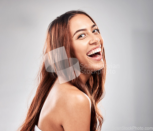 Image of Happy, portrait and woman in studio for hair, beauty and salon treatment on grey background. Face, haircare and model laughing for luxury, care and shine, keratin and smooth results isolated