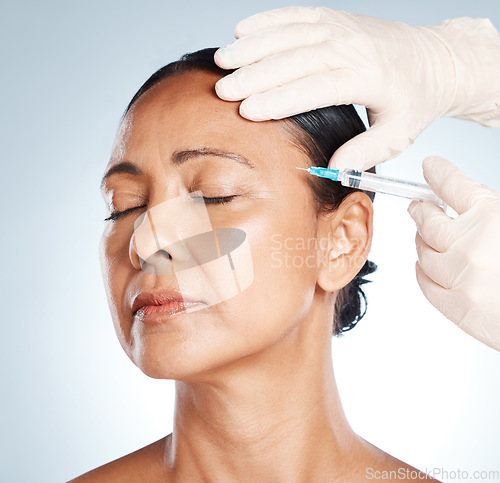 Image of Needle, woman face and plastic surgery for medical skincare, collagen or beauty. Botox cosmetics, facial injection and aesthetic filler for body transformation, change and makeup on studio background