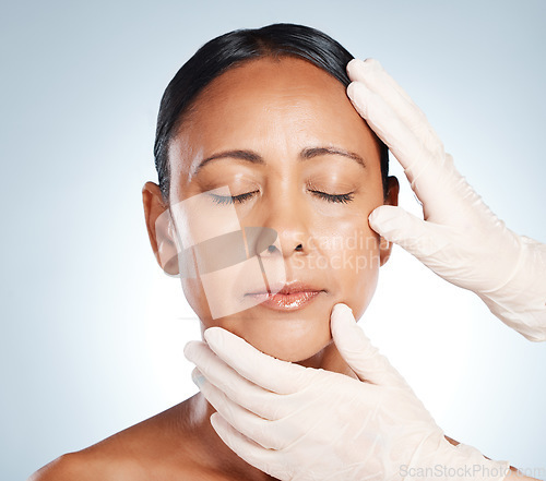 Image of Botox, plastic surgery and hands check woman face for laser, cosmetics implant or beauty salon. Skincare consultation, facial or gloves of aesthetic change, liposuction or filler on studio background