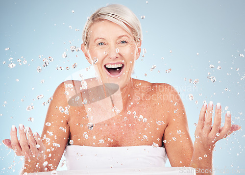 Image of Shower, face and old woman excited with water drops, clean skin and antiaging skincare, elderly model isolated on studio background. Beauty, senior cosmetic care and facial portrait, wow and hygiene