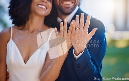 Image of Married couple, hands and wedding rings with smile for marriage, commitment or honeymoon in the outdoors. Hand of happy groom and bride smiling and showing ring in symbol for wife and husband