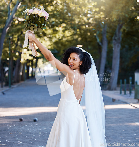 Image of Bride, wedding and black woman with flowers at park outdoors. Portrait, marriage or beauty of happy female holding up floral bouquet of roses to celebrate at party, ceremony event or love celebration