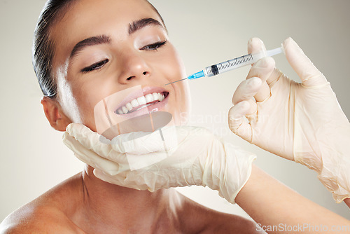 Image of Smile, beauty and woman with injection in lips from healthcare professional, anti aging wrinkle treatment in studio. Collagen, skincare and model with facial lip filler syringe on white background