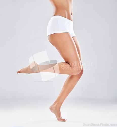 Image of Legs, skin and woman with body and balance in underwear isolated on studio background, epilation and skincare beauty. Hair removal mockup, grooming and wellness glow, feet and pedicure with hygiene