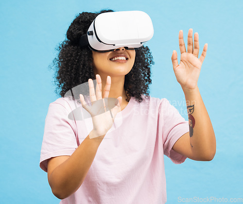 Image of Black woman with virtual reality glasses, happy with hands in metaverse, VR and futuristic tech isolated on blue background. Gaming, web and augmented reality, ux in studio and future technology