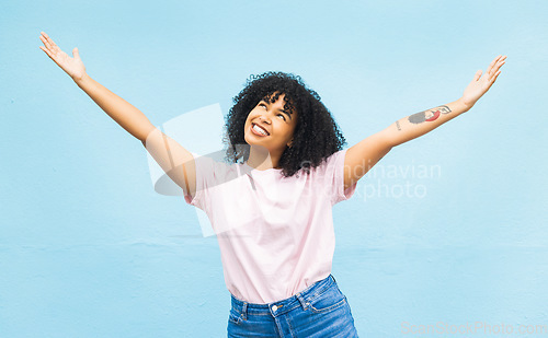 Image of African woman, smile and open arms in studio for mockup, happiness celebration and excited in blue background. Black woman, happy and surprised hands gesture or celebrate surprise growth development